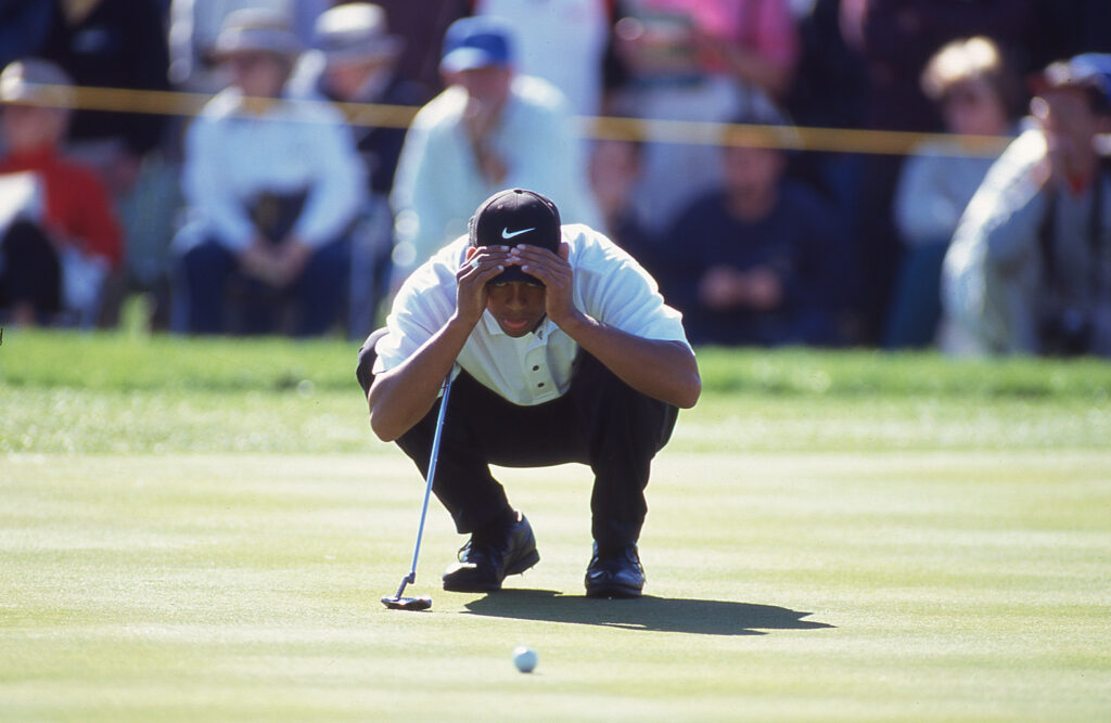 Golfer on grass holding head